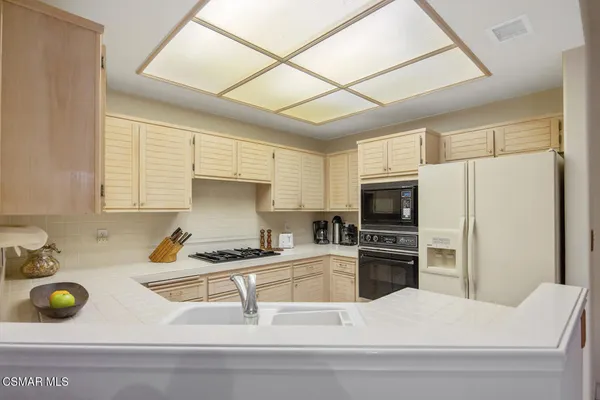 a kitchen with a stove a refrigerator and a sink