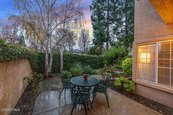 a backyard of a house with table and chairs