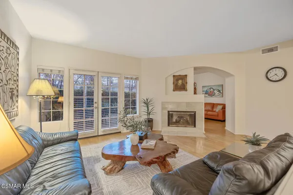 a living room with furniture a fireplace and a table