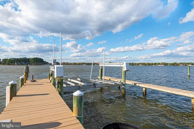 a kitchen with kitchen island granite countertop a sink a center island and cabinets