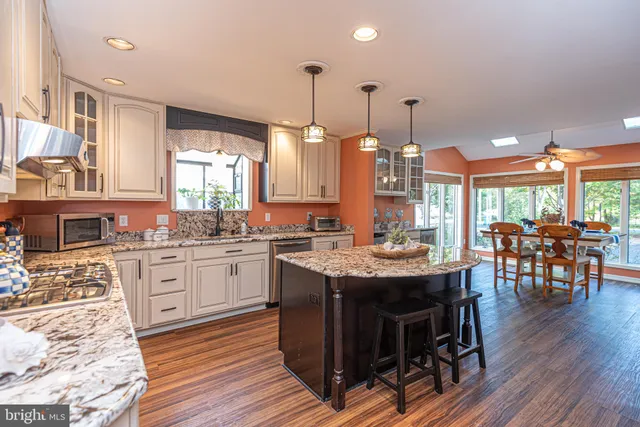 a bedroom with a bed a chandelier and a couch