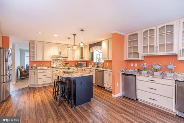 a living room with furniture a fireplace and a large window