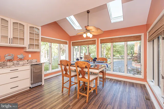 a spacious bathroom with a granite countertop sink and a mirror