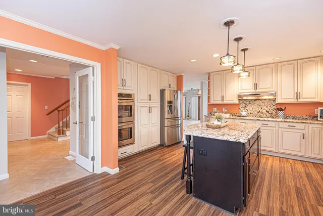 a view of an empty room with cabinet and mirrors