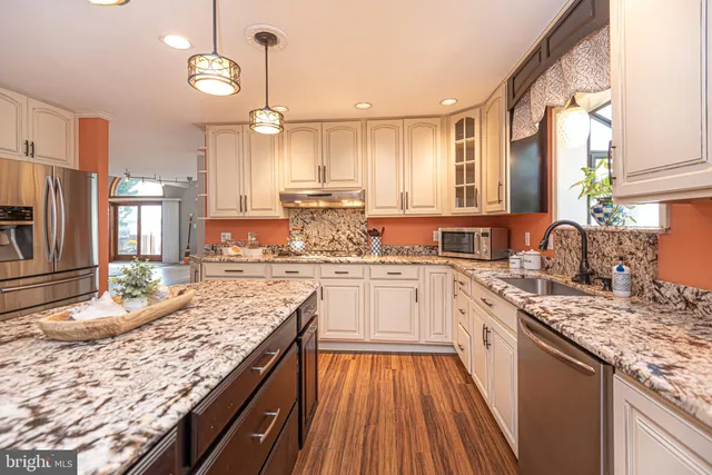 a bedroom with two beds and a painting on the wall