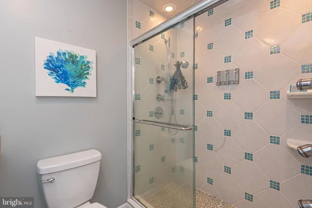 an aerial view of a house with swimming pool and large trees