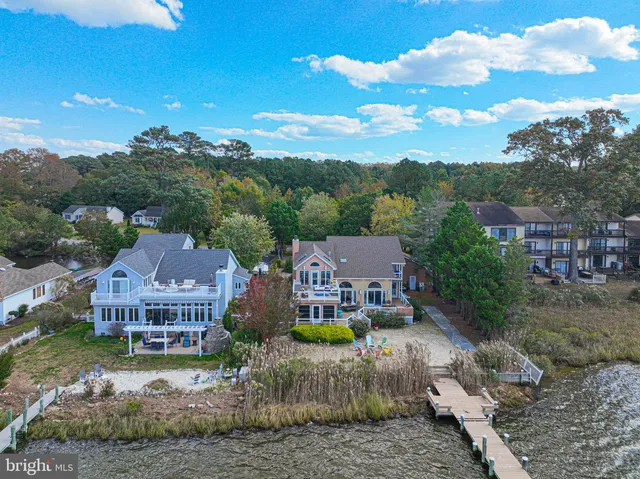 a view of a house with backyard sitting area and furniture