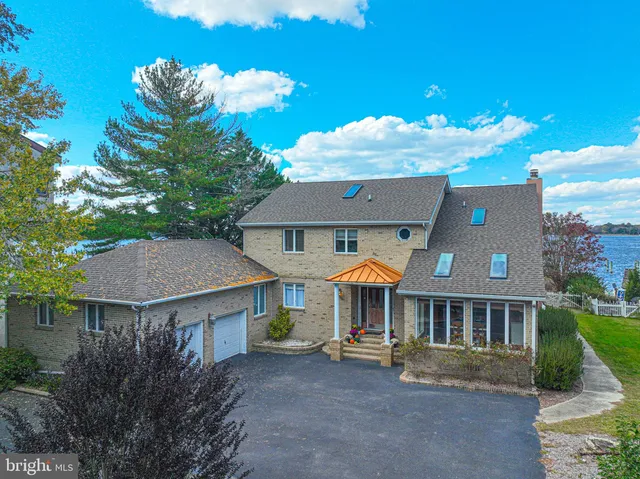 a view of a house with backyard sitting area and furniture