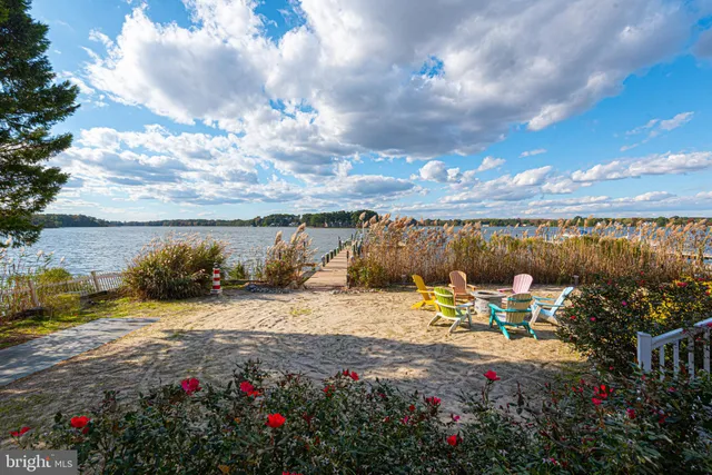 a view of a rooftop deck with couch and chairs