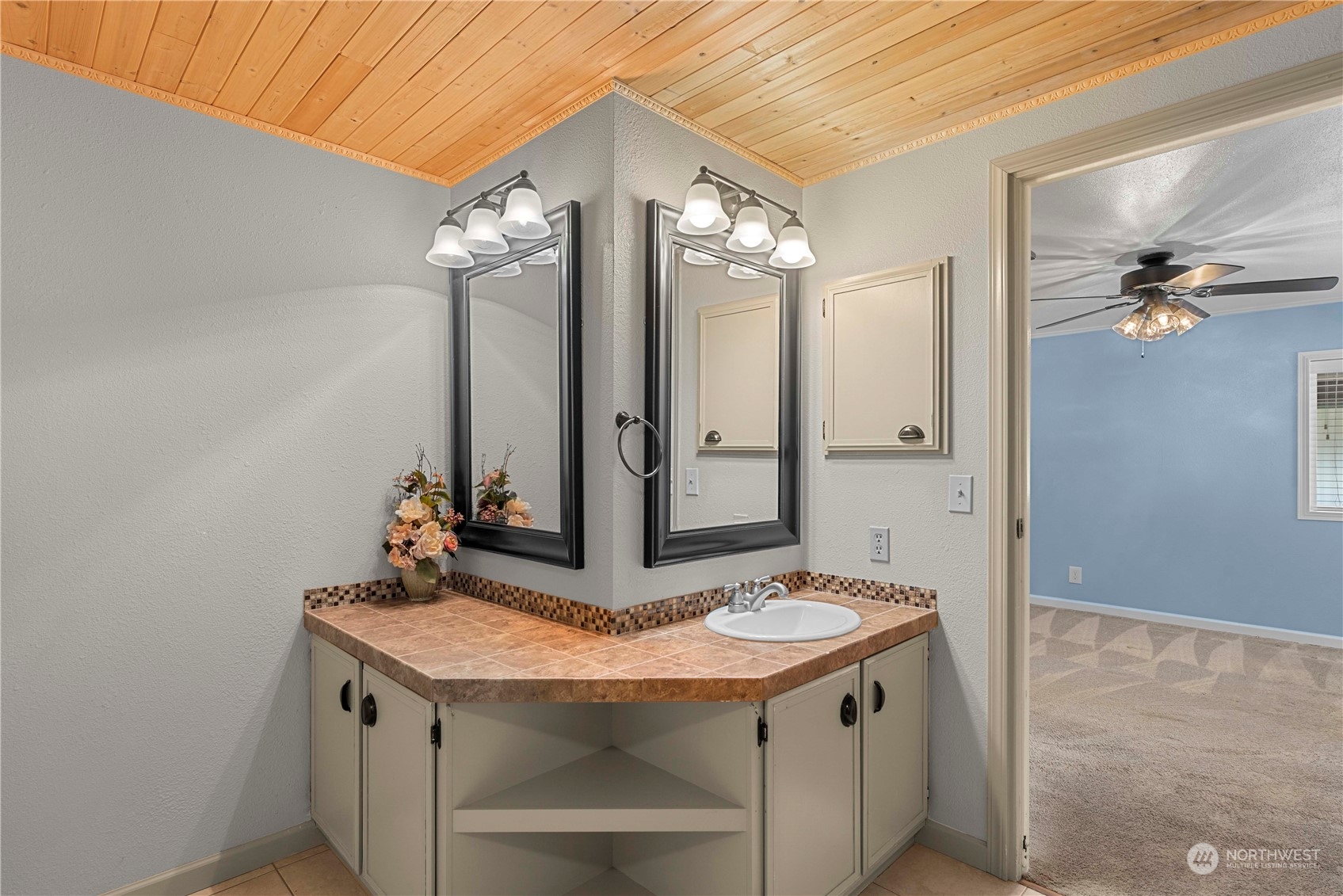 7900 Stine Hill Road, Unit 11 Cashmere, WA 98815 - Photo 18 of 39 a bathroom with a granite countertop sink a large mirror and a shower