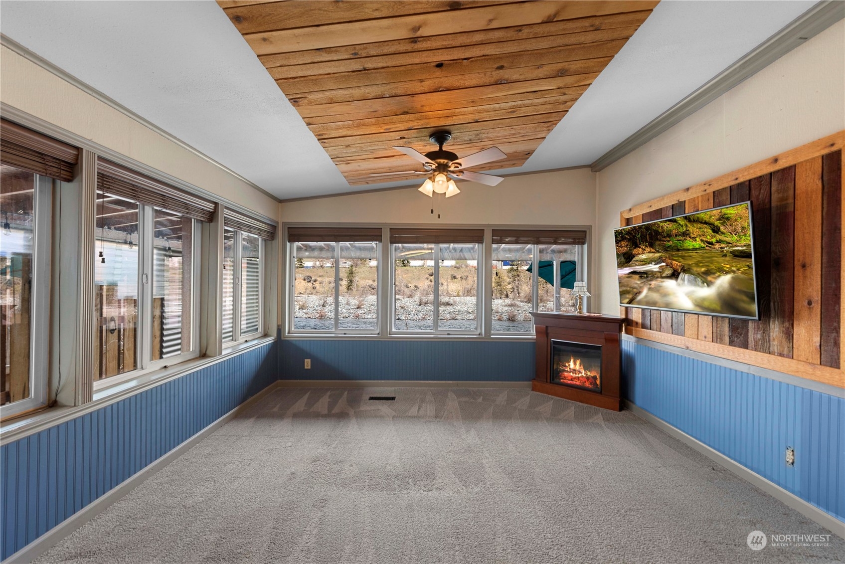 7900 Stine Hill Road, Unit 11 Cashmere, WA 98815 - Photo 9 of 39 a living room with fireplace furniture and a flat screen tv