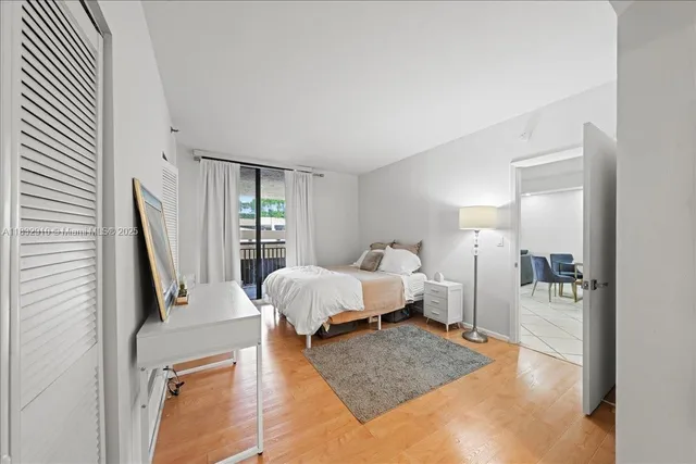 a spacious bedroom with a bed a couch and dresser