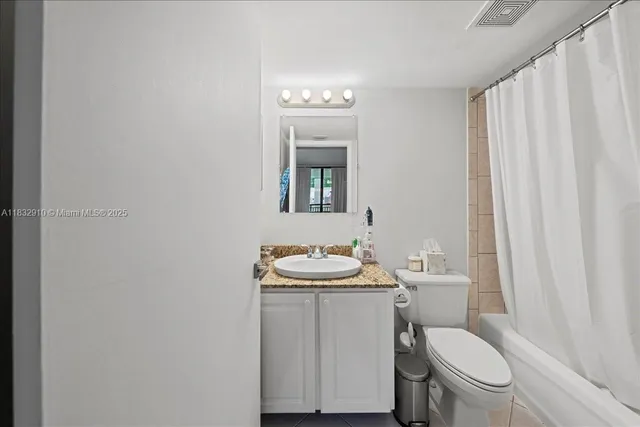 a bathroom with a sink toilet and a mirror
