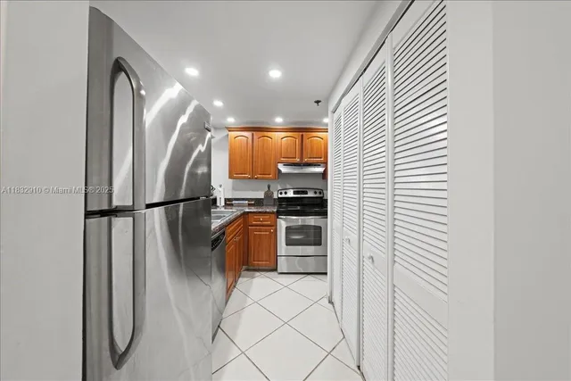 a kitchen with stainless steel appliances a refrigerator and a stove top oven