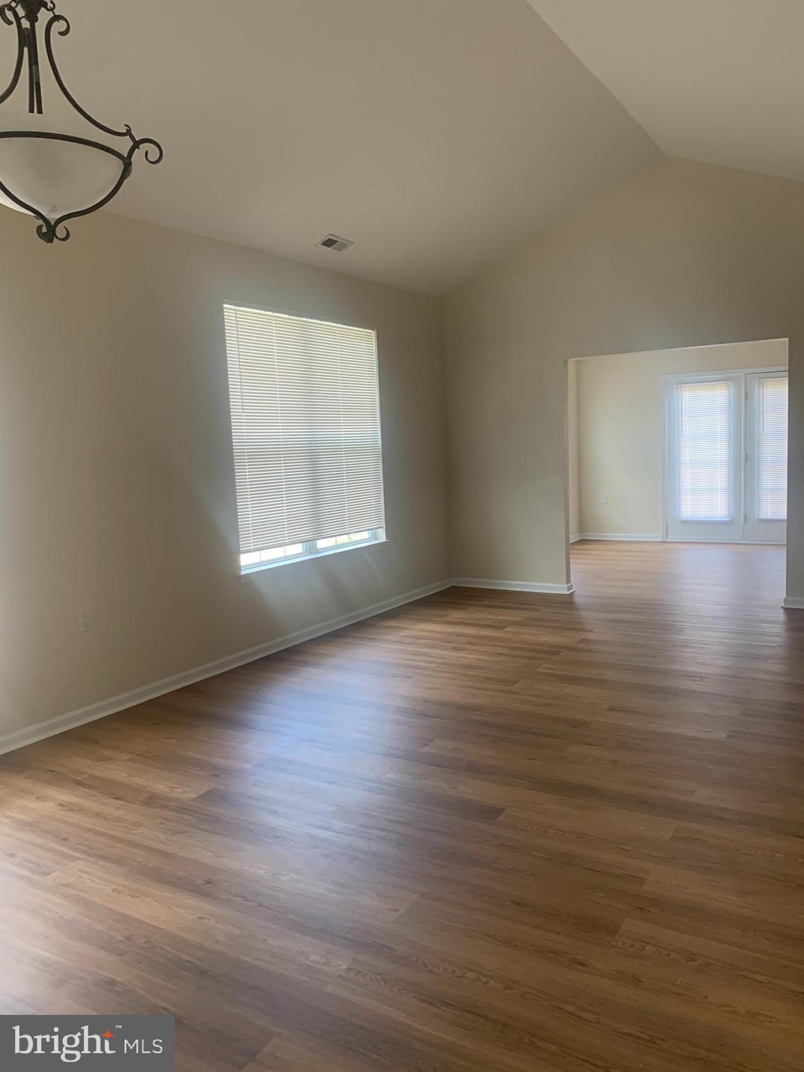207 Devon Lane Hainesport, NJ 08036 - Photo 3 of 12 a view of an empty room with wooden floor and a window