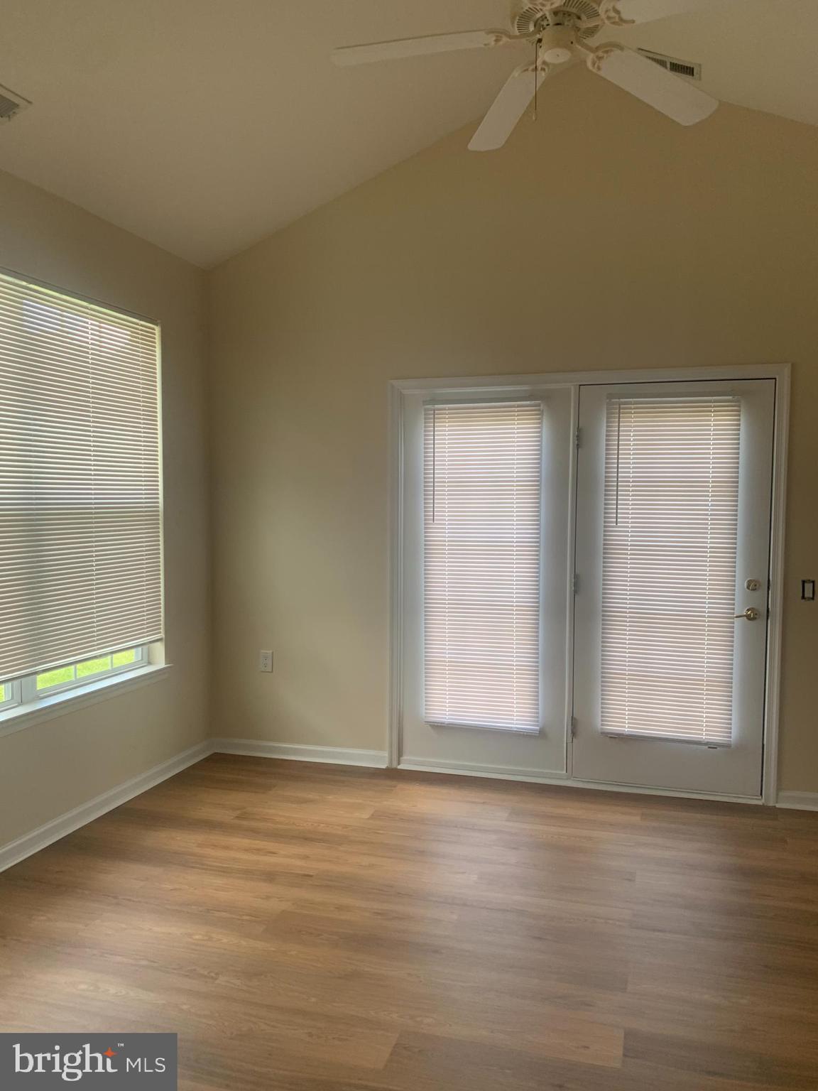 207 Devon Lane Hainesport, NJ 08036 - Photo 4 of 12 an empty room with wooden floor and windows