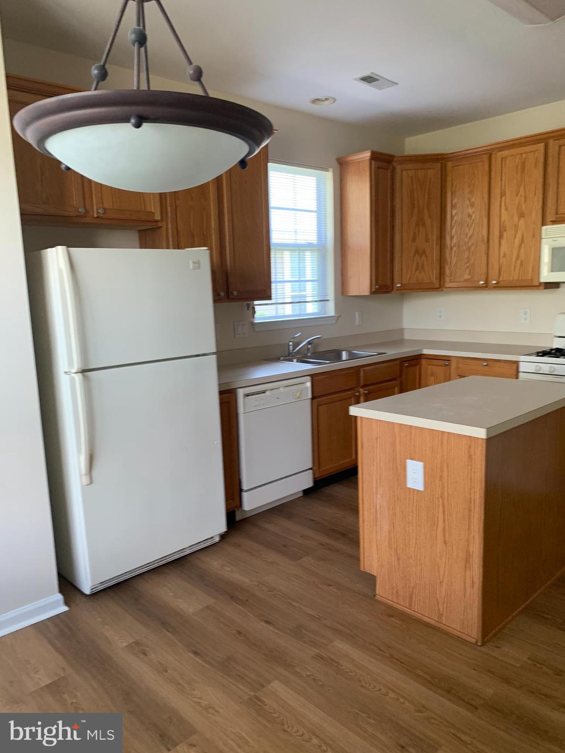 207 Devon Lane Hainesport, NJ 08036 - Photo 6 of 12 a kitchen with stainless steel appliances granite countertop a refrigerator a sink a stove with wooden floors