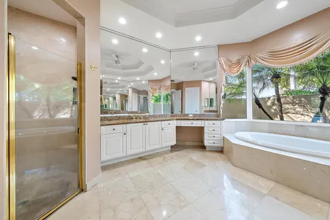 a bathroom with a granite countertop sink a toilet and a mirror