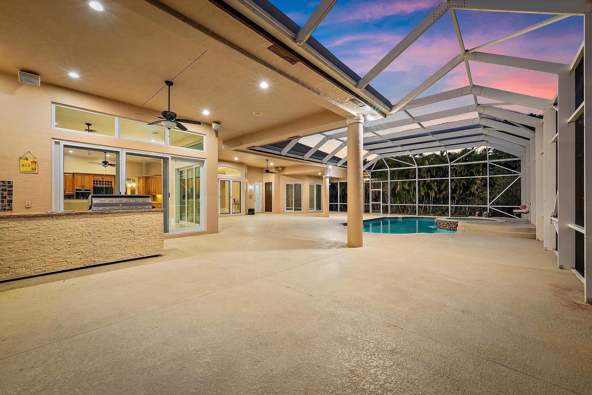 8480 Man O War Road Palm Beach Gardens, FL 33418 - Photo 29 of 45 Covered Lanai & Screened In Pool