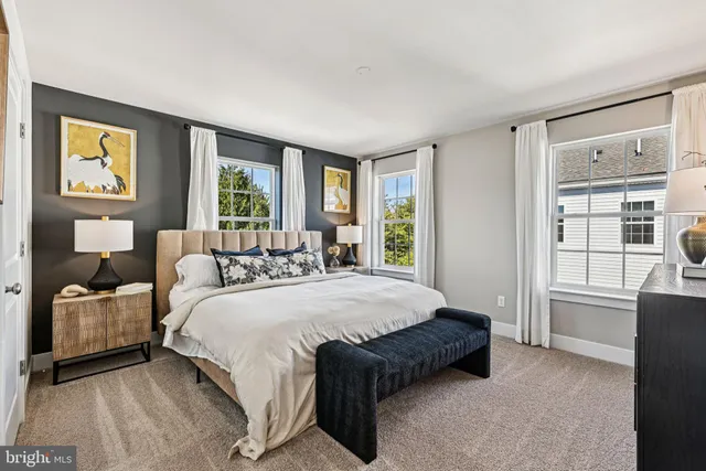 a spacious bedroom with a bed and glass door