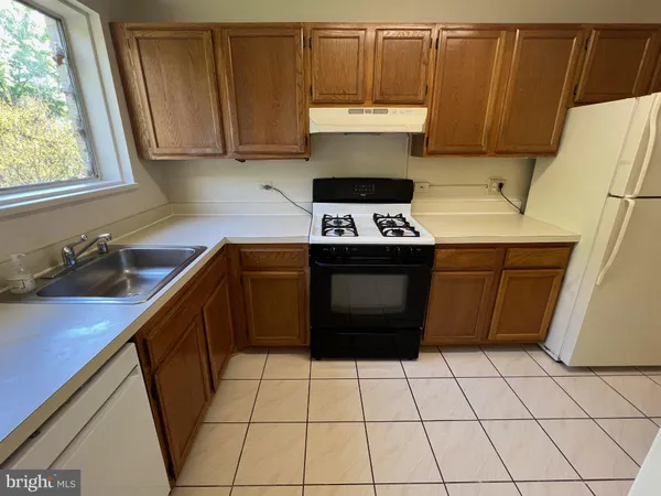 a kitchen with a cabinets and a stove top oven