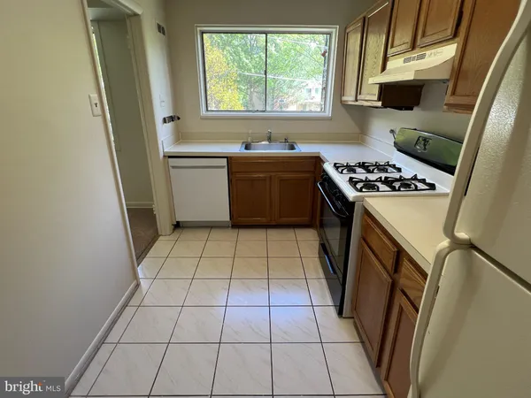 a kitchen with a sink a stove a refrigerator and window