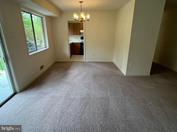 an empty room with a empty space and windows