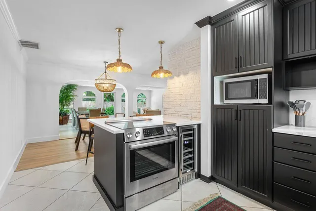 a kitchen with a stove and a wooden floors