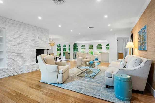 a living room with fireplace furniture and a wooden floor