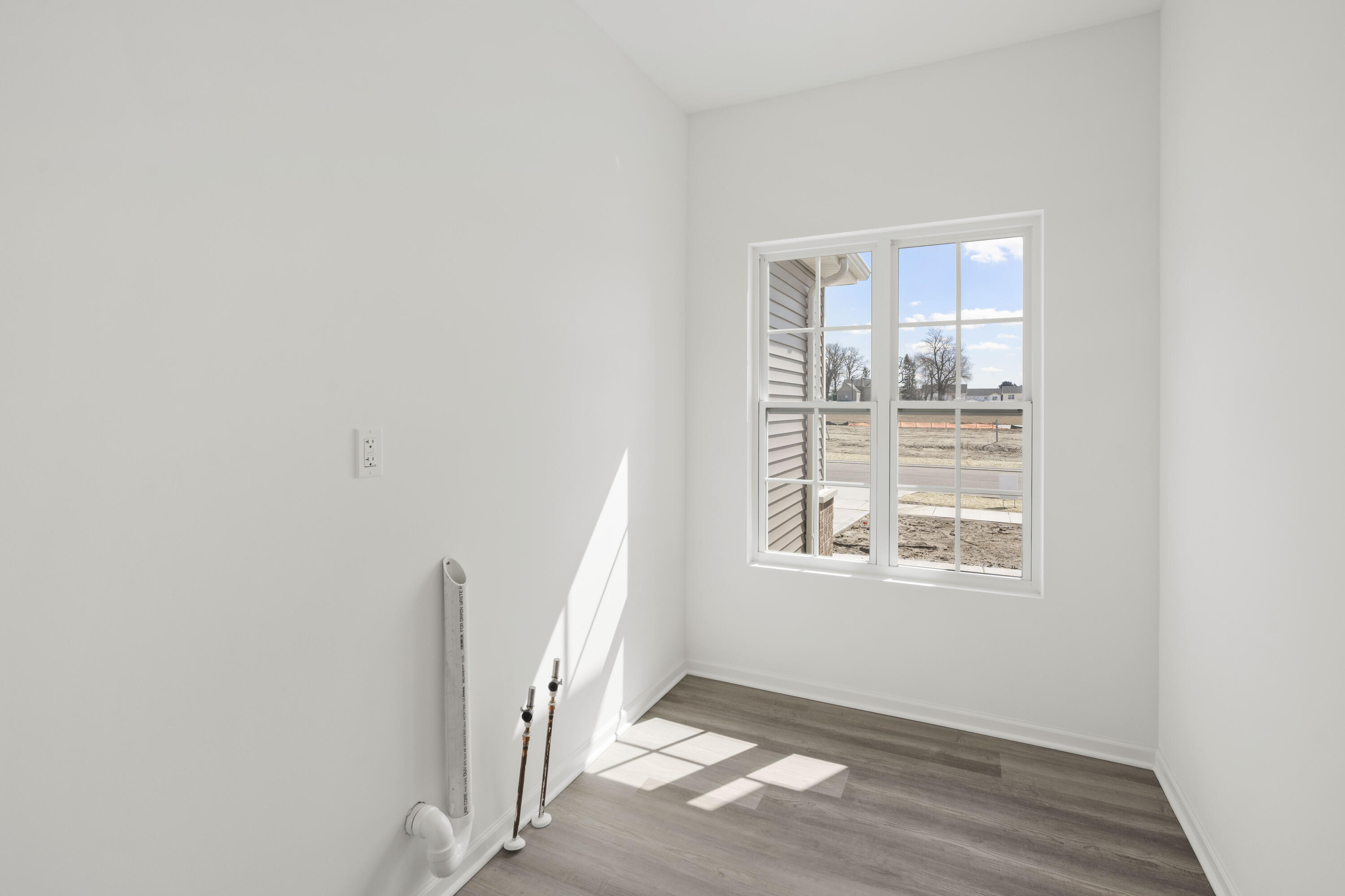 6561 East 103rd Avenue Crown Point, IN 46307 - Photo 11 of 11 a view of an empty room with wooden floor and a window