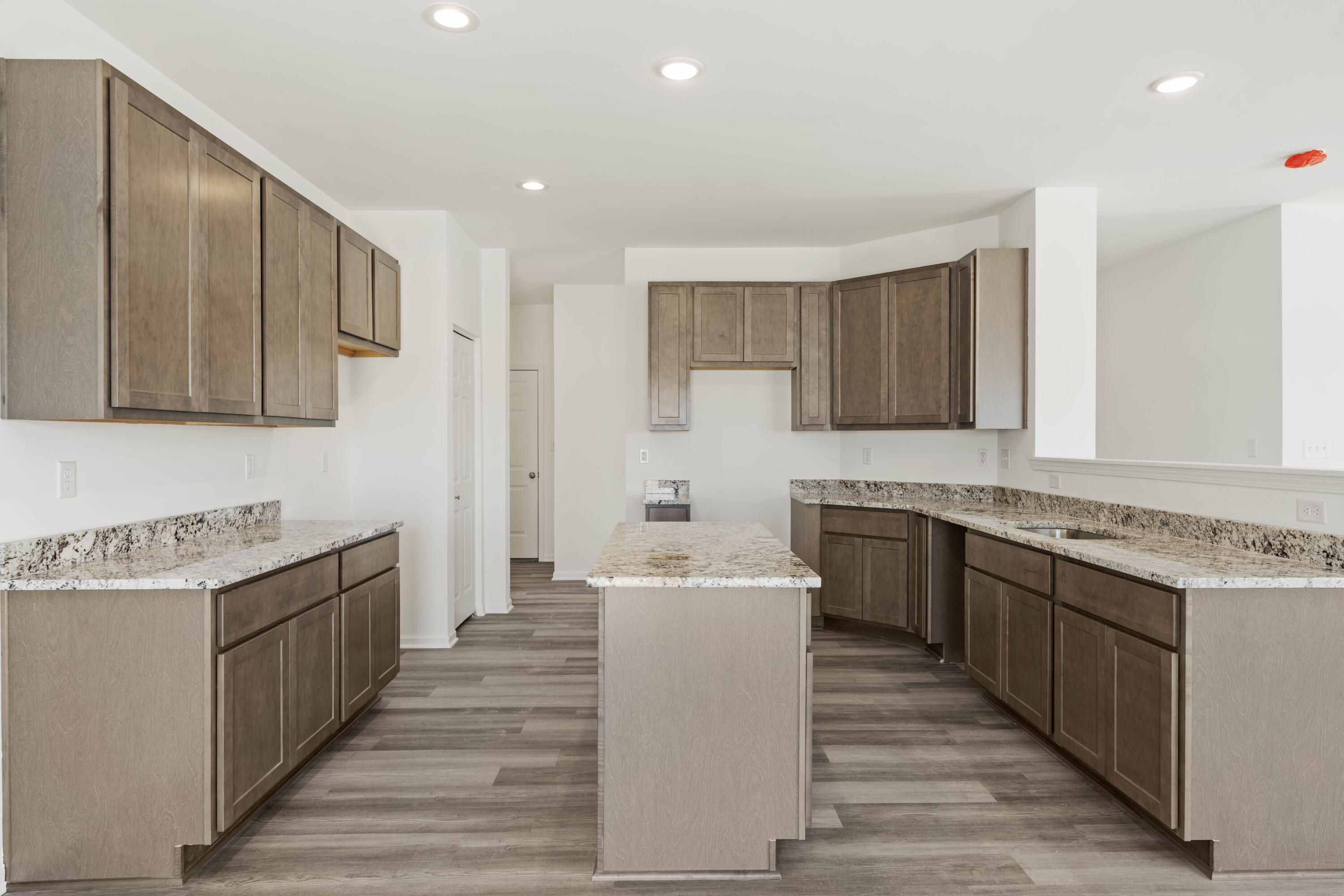 6561 East 103rd Avenue Crown Point, IN 46307 - Photo 7 of 11 a kitchen with stainless steel appliances granite countertop a sink stove and cabinets
