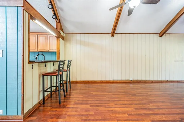 a view of a room with wooden floor and windows