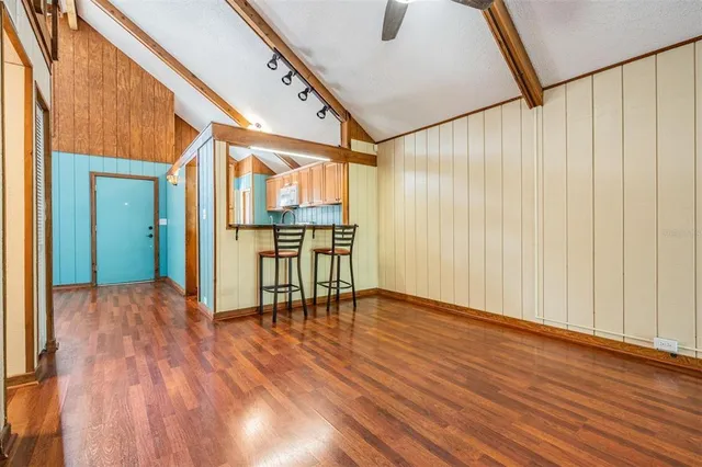 a view of empty room with wooden floor