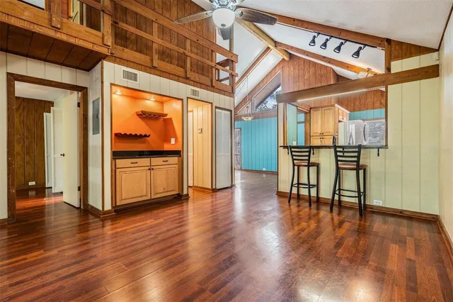 a view of empty room with wooden floor