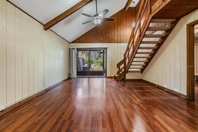 a view of an entryway with wooden floor and stairs