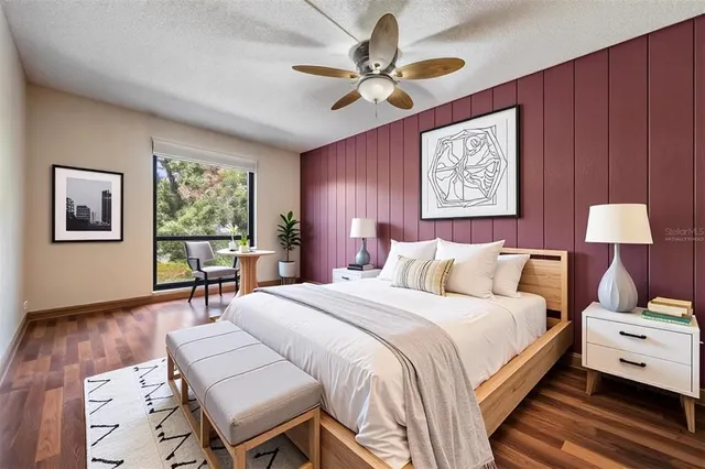 a bedroom with a bed and a table with chair