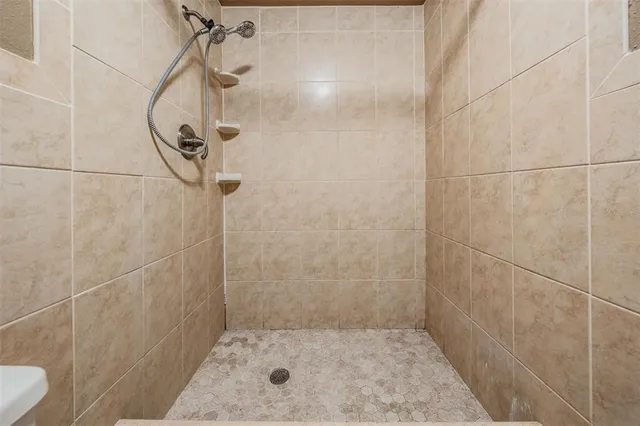 a bathroom with a glass shower door