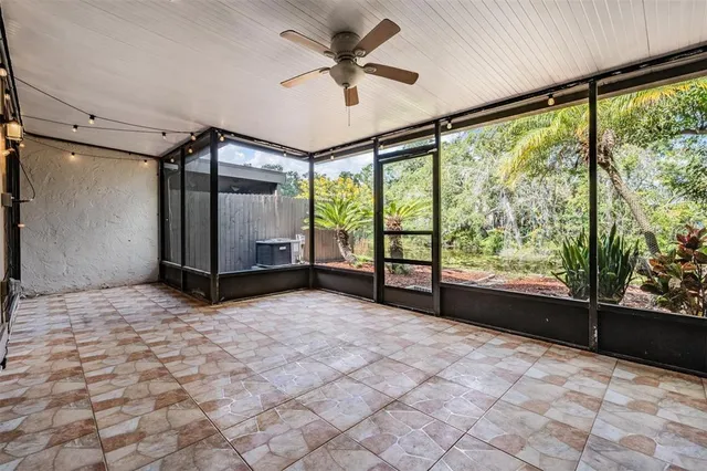 a view of a livingroom with a ceiling fan and window
