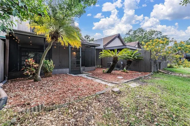 a front view of a house with a yard and a garden