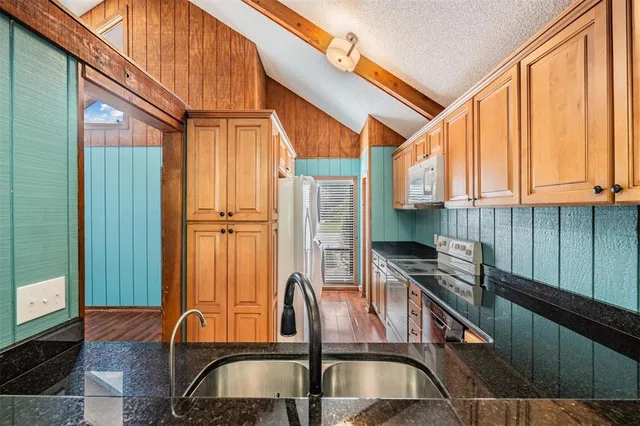 a view of two chairs and table in the balcony