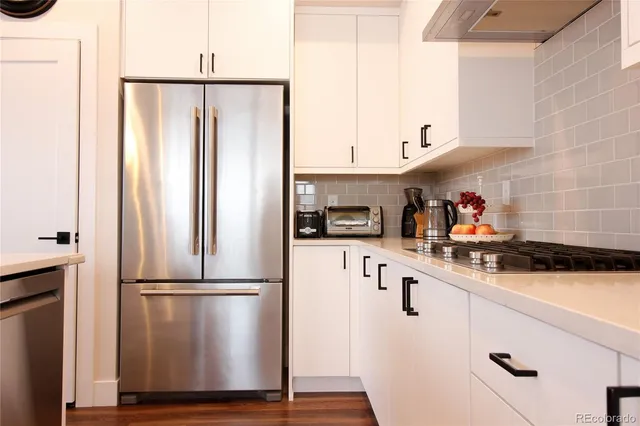 a kitchen with stainless steel appliances a refrigerator sink and cabinets
