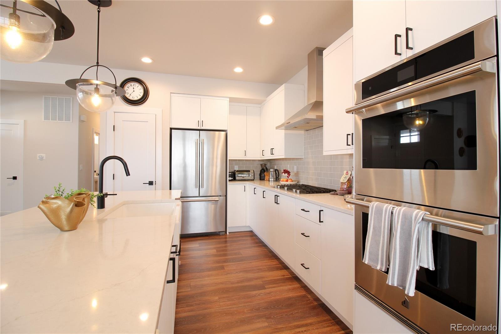 10394 Detroit Street Denver, CO 80229 - Photo 14 of 50 a kitchen with stainless steel appliances a white cabinet and a sink