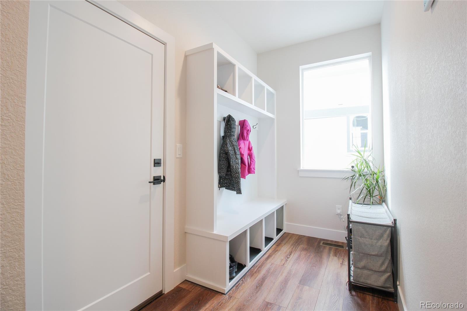 10394 Detroit Street Denver, CO 80229 - Photo 19 of 50 a view of hallway with window and wooden floor