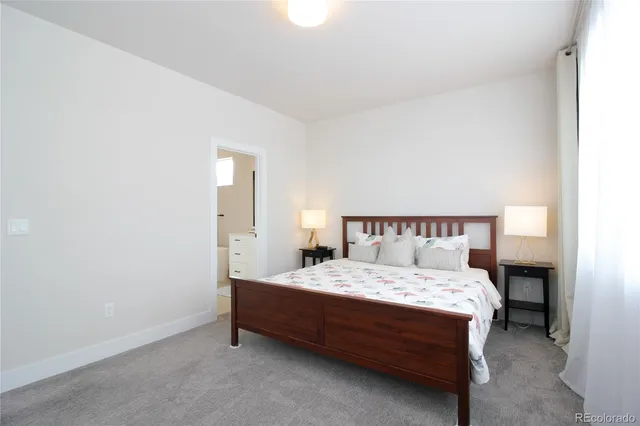 a bedroom with a bed and a lamp