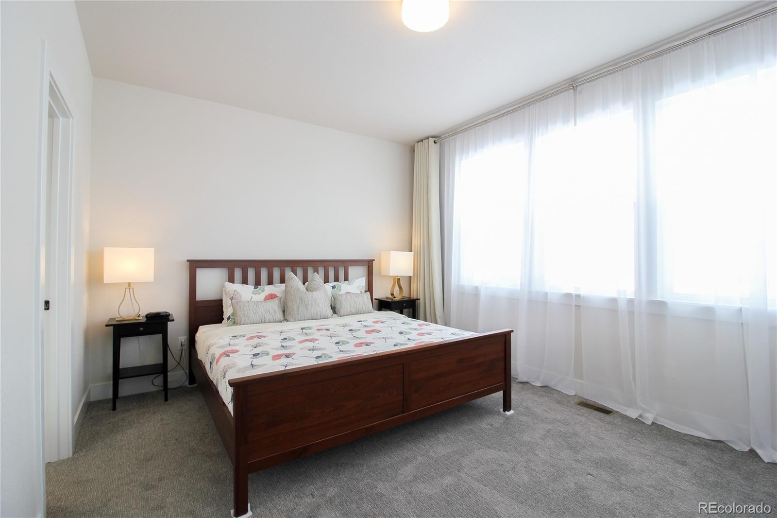 10394 Detroit Street Denver, CO 80229 - Photo 22 of 50 a bedroom with a bed and a window