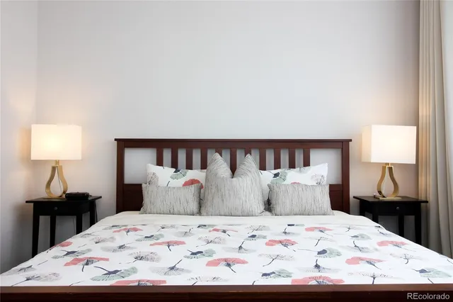 a bedroom with a bed and a lamp