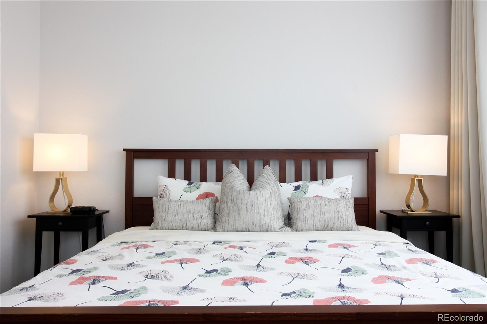 10394 Detroit Street Denver, CO 80229 - Photo 23 of 50 a bedroom with a bed and a lamp