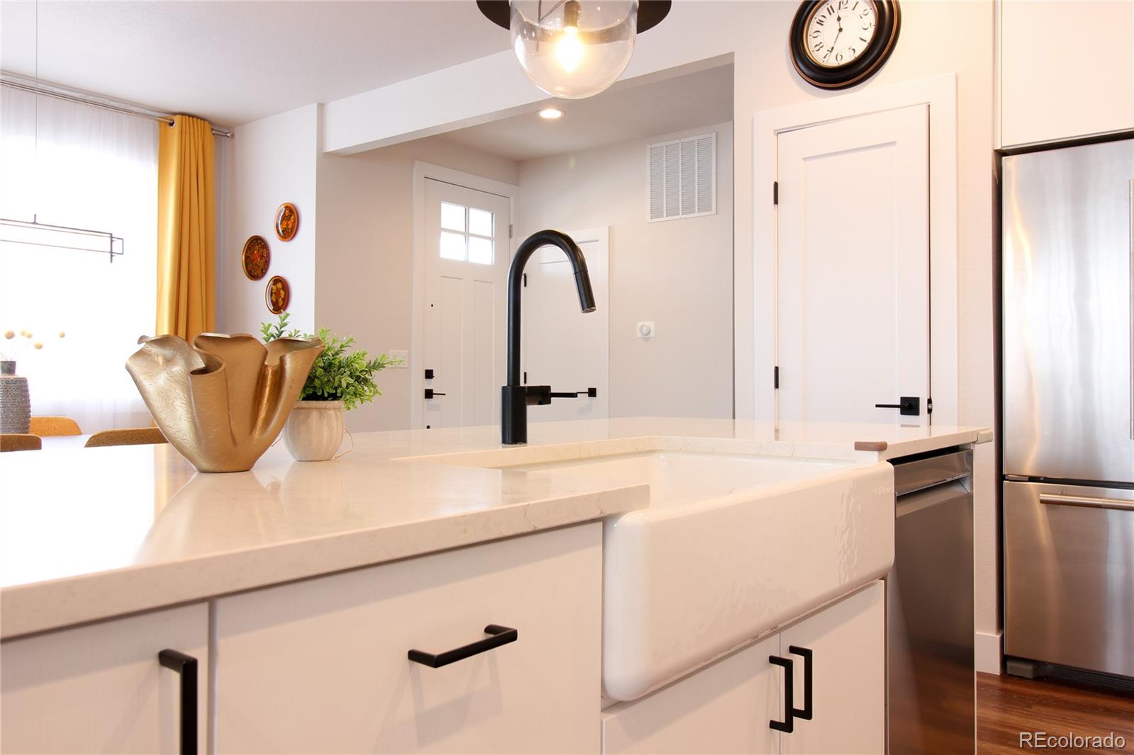 10394 Detroit Street Denver, CO 80229 - Photo 29 of 50 a kitchen with a sink and a refrigerator