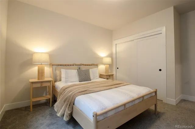 a bedroom with a bed and a night stand