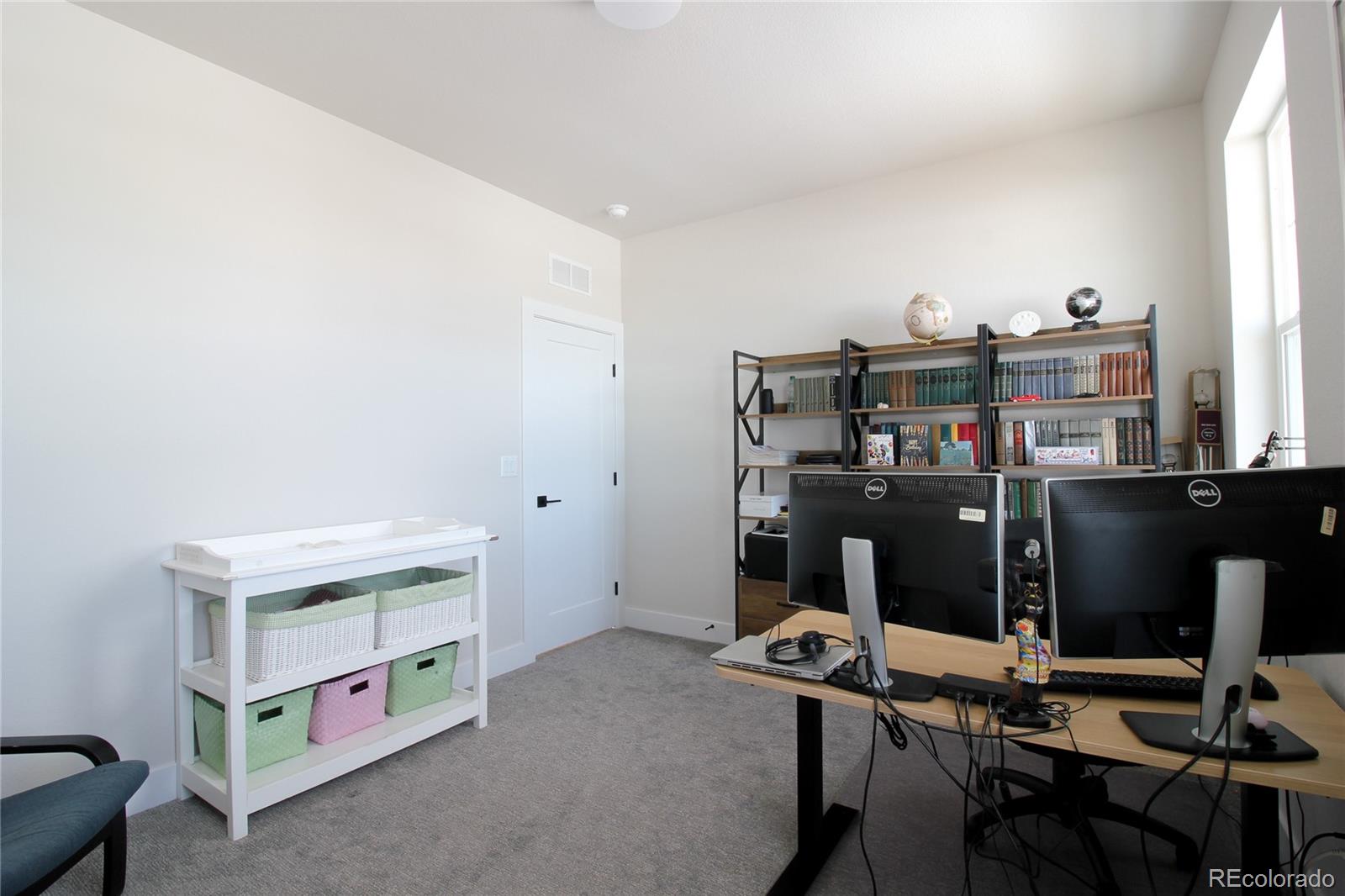 10394 Detroit Street Denver, CO 80229 - Photo 39 of 50 a room with furniture and musical instruments